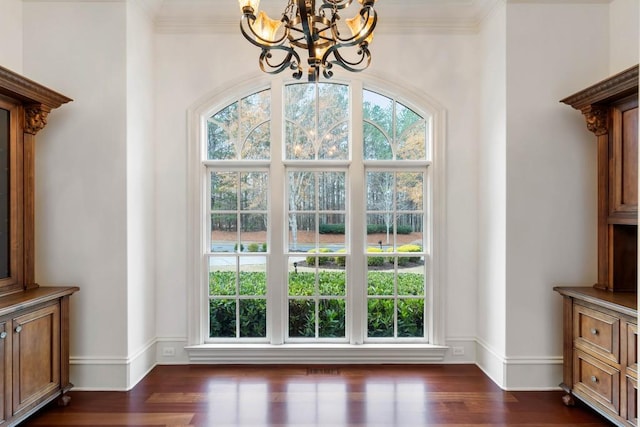 entryway featuring dark hardwood / wood-style floors, a wealth of natural light, and crown molding