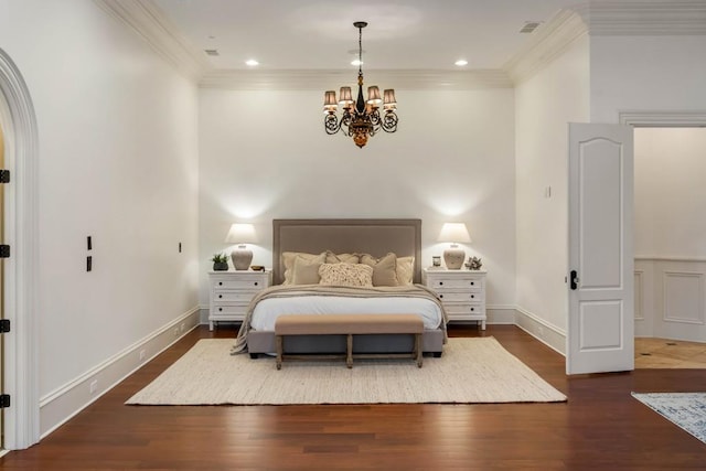 bedroom featuring ornamental molding, dark wood-type flooring, and a notable chandelier