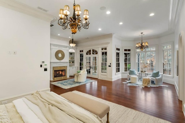 living room featuring crown molding, dark hardwood / wood-style flooring, and a chandelier