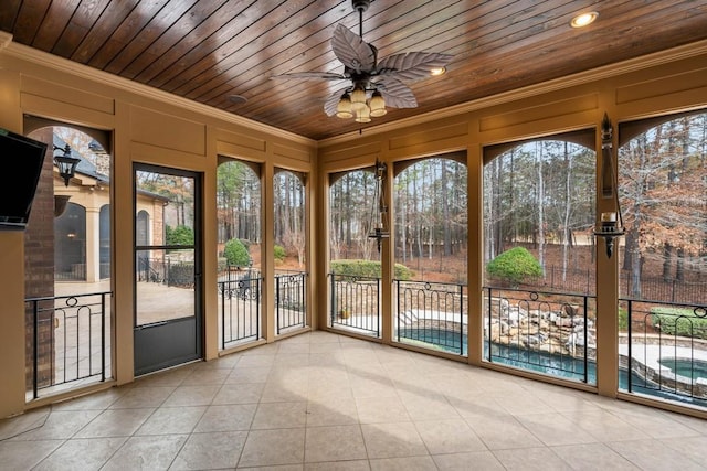 unfurnished sunroom with ceiling fan and wood ceiling