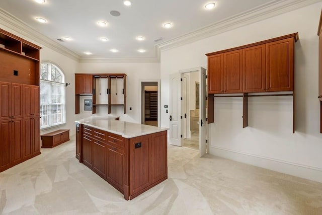 kitchen with light stone countertops, crown molding, a center island, and light colored carpet