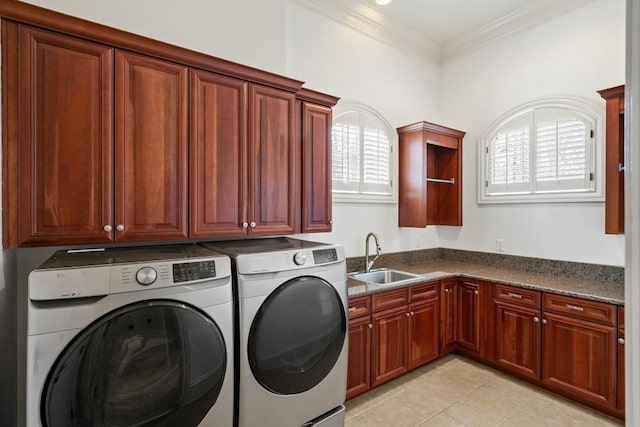 clothes washing area featuring cabinets, ornamental molding, washer and clothes dryer, sink, and light tile patterned floors