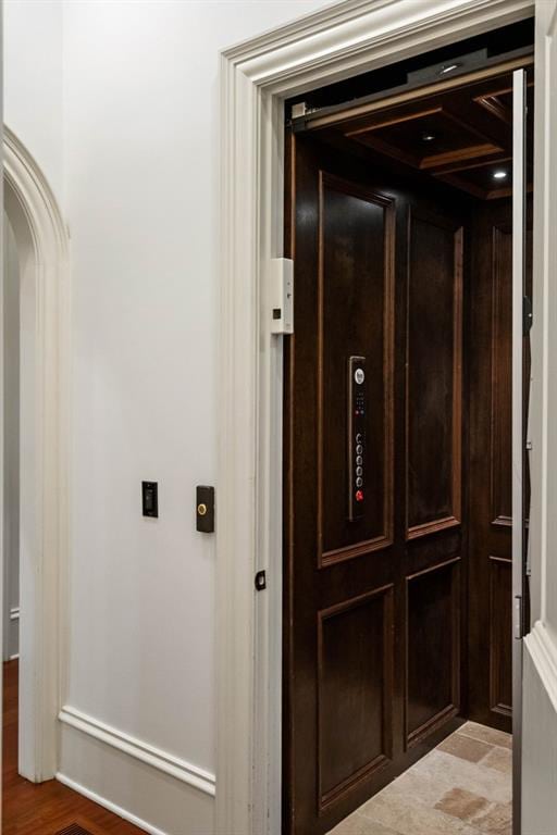 details with hardwood / wood-style floors and elevator