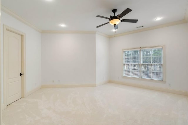 empty room with light colored carpet and crown molding