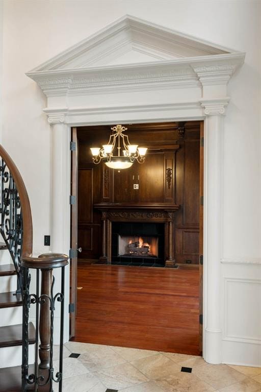 interior space featuring hardwood / wood-style floors, an inviting chandelier, and ornamental molding