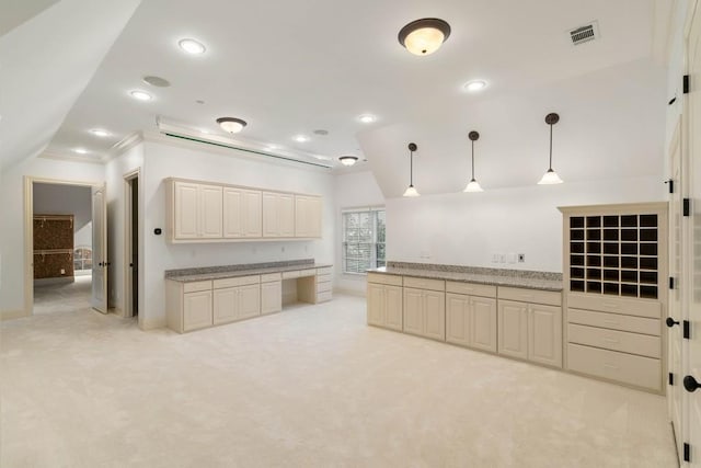 kitchen with lofted ceiling, crown molding, light colored carpet, and decorative light fixtures