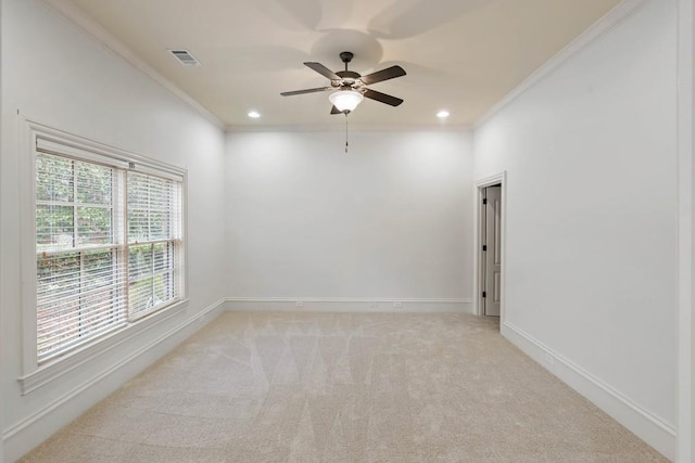 carpeted spare room with crown molding and ceiling fan