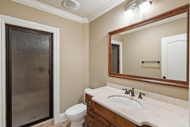 bathroom with vanity, toilet, a shower with door, and ornamental molding