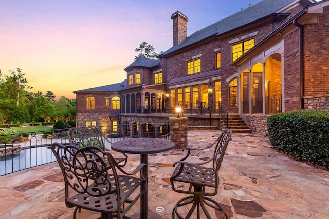 view of patio terrace at dusk