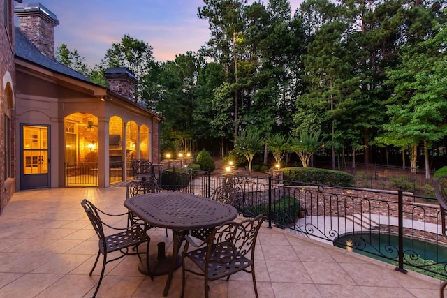 view of patio terrace at dusk