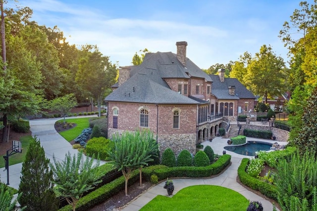 rear view of house with a yard