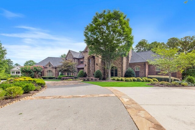 english style home with a front yard