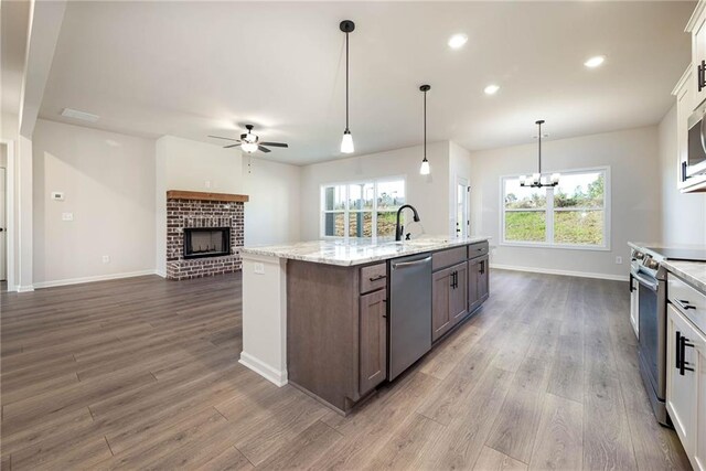 106 Harmony Farms Orch, Eatonton, GA 31024 - kitchen featuring hardwood / wood-style floors, white cabinetry, stainless steel appliances, and a wealth of natural light