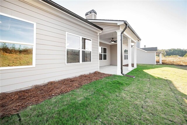 106 Harmony Farms Orch, Eatonton, GA 31024 - view of side of property featuring a lawn, ceiling fan, and a patio