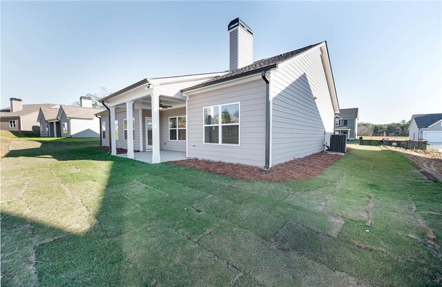 106 Harmony Farms Orch, Eatonton, GA 31024 - rear view of property with central AC unit, a patio area, and a yard