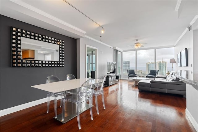 dining area with crown molding, baseboards, ceiling fan, and hardwood / wood-style floors