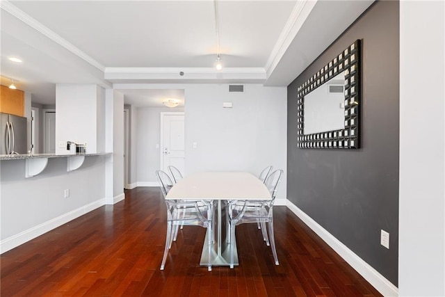 dining room featuring visible vents, crown molding, baseboards, and dark wood-type flooring