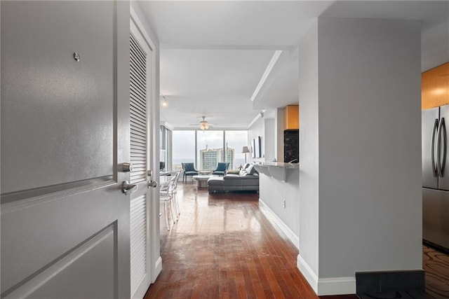 hallway with baseboards, hardwood / wood-style floors, and french doors