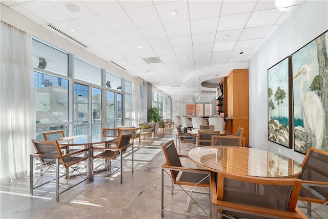 dining room with visible vents and a paneled ceiling