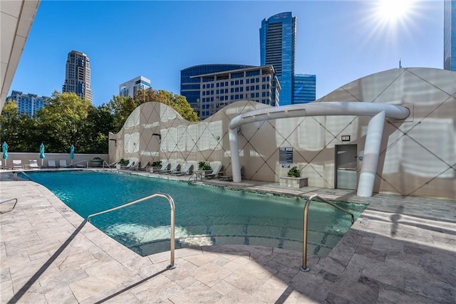 community pool featuring a patio area and a city view