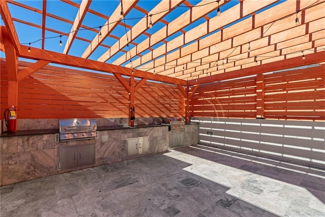 view of patio / terrace with exterior kitchen, a pergola, and area for grilling