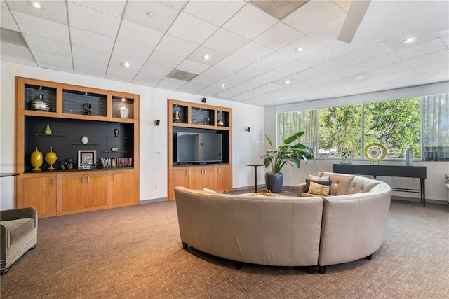 carpeted living room with baseboards, recessed lighting, and built in features