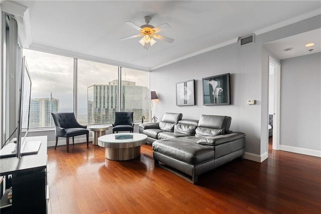 living room featuring crown molding, a ceiling fan, baseboards, and wood finished floors