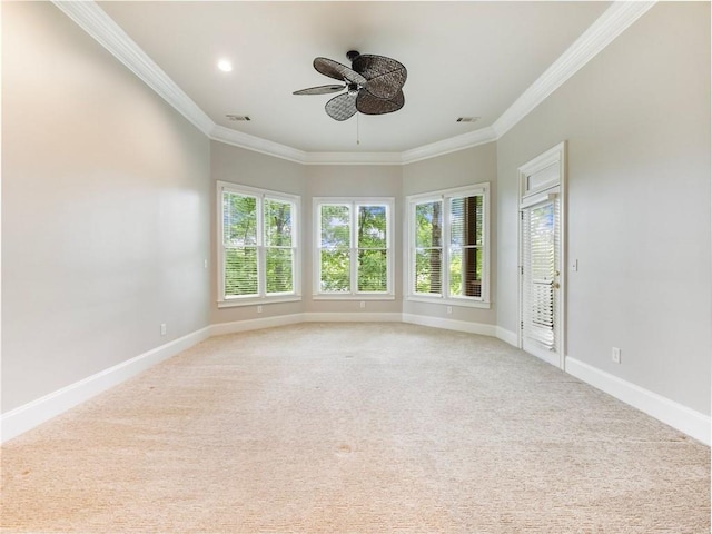unfurnished room featuring visible vents, baseboards, a ceiling fan, crown molding, and light carpet