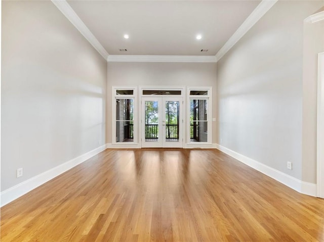 spare room with baseboards, light wood-type flooring, crown molding, recessed lighting, and french doors