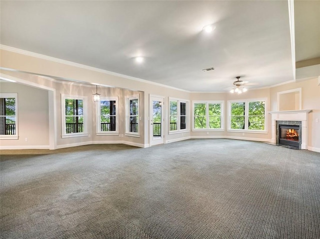 unfurnished living room with crown molding, ceiling fan, a fireplace, carpet, and baseboards