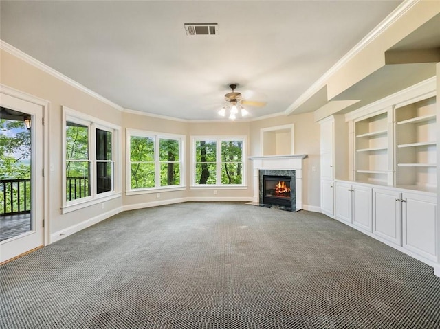 unfurnished living room featuring crown molding, visible vents, ceiling fan, and carpet