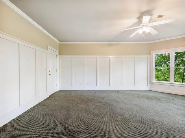 unfurnished bedroom featuring a decorative wall, carpet, crown molding, and a ceiling fan