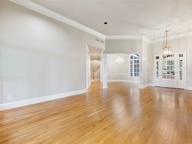 unfurnished living room with visible vents, a notable chandelier, ornamental molding, light wood-type flooring, and stairway