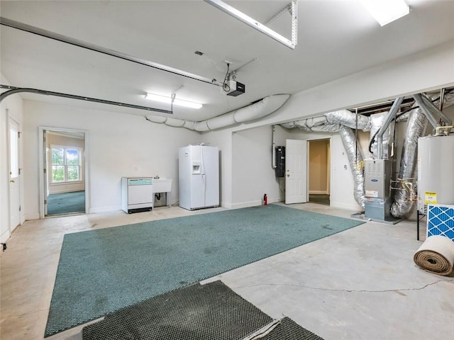 garage featuring white refrigerator with ice dispenser, heating unit, gas water heater, a garage door opener, and a sink