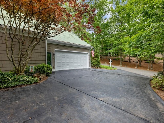garage with aphalt driveway