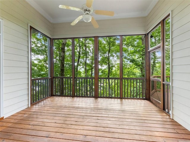 unfurnished sunroom featuring ceiling fan