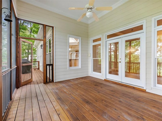 unfurnished sunroom with french doors and a ceiling fan