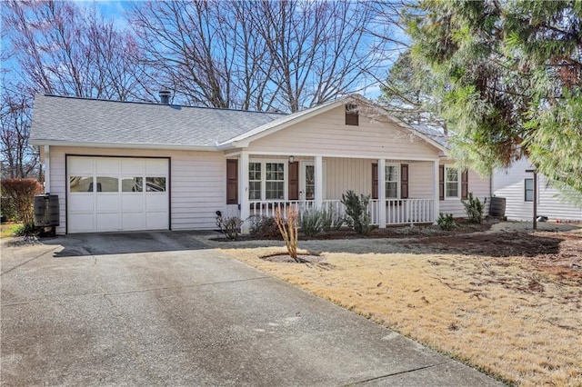 ranch-style home featuring covered porch, an attached garage, a shingled roof, and driveway