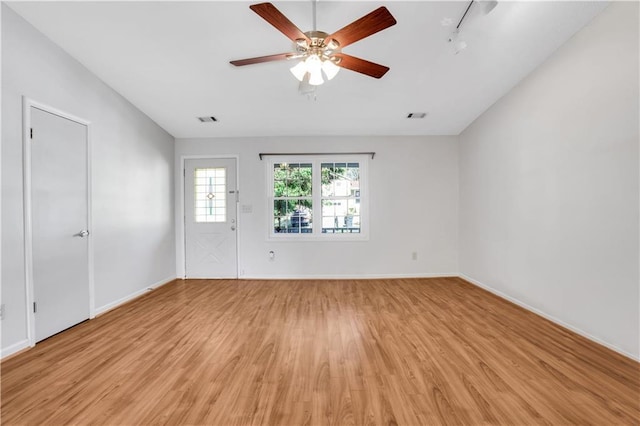 unfurnished living room featuring ceiling fan, visible vents, baseboards, and light wood-style flooring