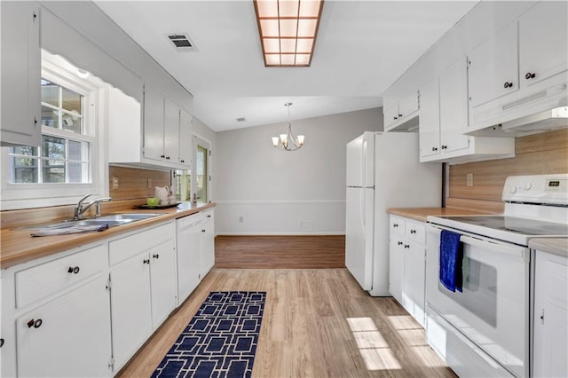 kitchen featuring under cabinet range hood, visible vents, white cabinets, and white appliances