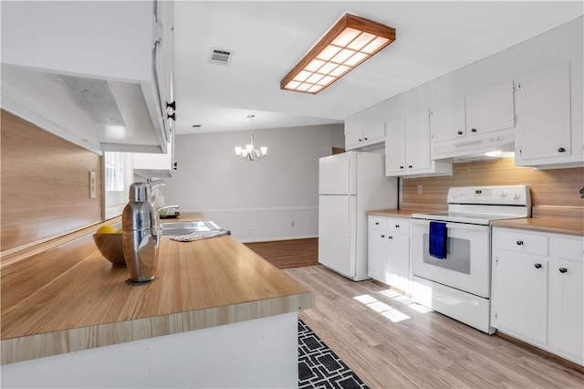 kitchen featuring under cabinet range hood, visible vents, white cabinets, and white appliances