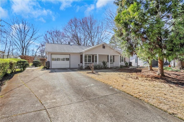 ranch-style house with covered porch, driveway, and a garage