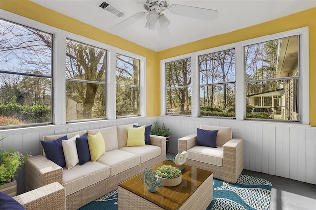 sunroom / solarium with a ceiling fan and visible vents