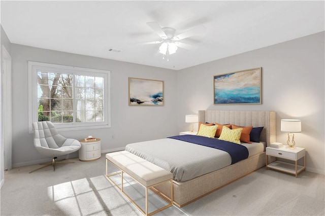 carpeted bedroom with a ceiling fan, visible vents, and baseboards