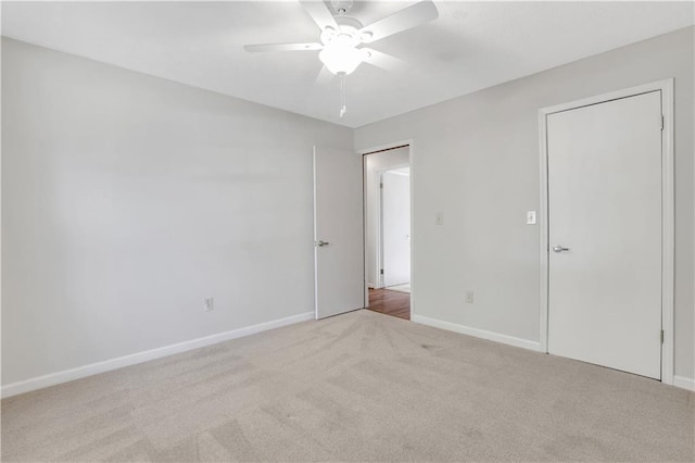 unfurnished bedroom featuring baseboards, carpet, and a ceiling fan