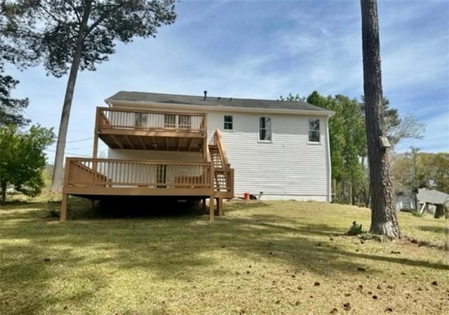 back of property featuring a lawn and a wooden deck