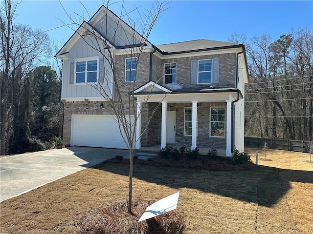 view of front facade with a garage, a front yard, and a porch