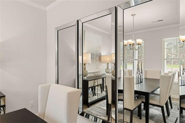 dining space with crown molding and a chandelier