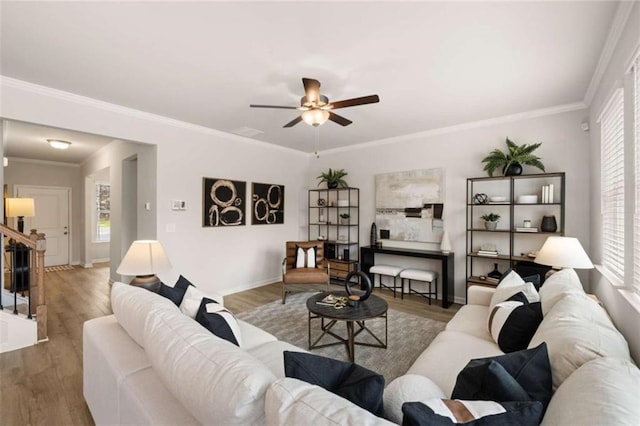 living room featuring ornamental molding, hardwood / wood-style floors, and ceiling fan