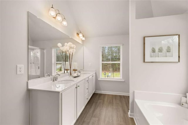 bathroom featuring lofted ceiling, plus walk in shower, hardwood / wood-style floors, and vanity